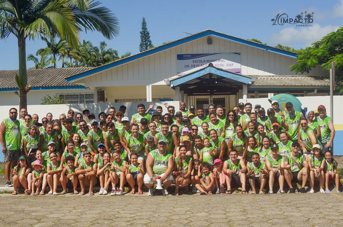Equipe de 2025, de camiseta verde, em frente à escola em Guaratuba
